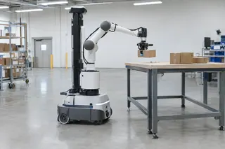 Robotic arm places cardboard boxes on a table in a spacious warehouse with shelves and bright overhead lights.